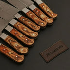 7-Piece Damascus Steel Kitchen Knife Collection with Flowing Water Pattern Blades.